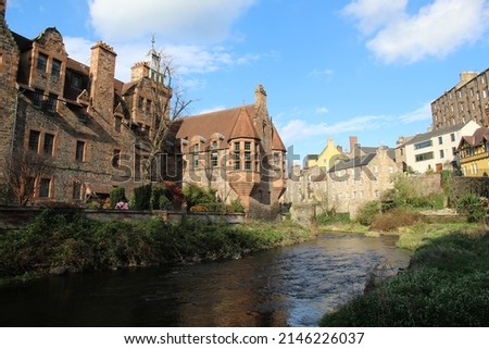 Old Picturesque Buildings of the Dean Village With the Water of Leith River on Partly Cloudy Blue Sky Background in Edinburgh Scotland