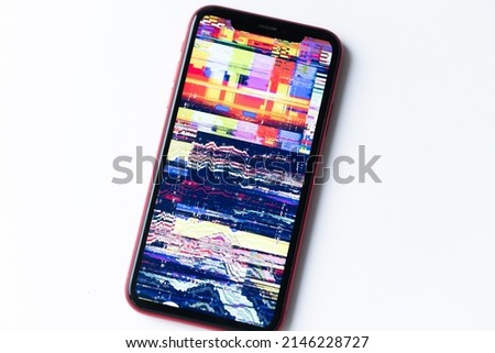 smartphone, mobile phone closeup. Glitches, distorted, corrupted image with colorful lines on the phone. Color channels effect.
