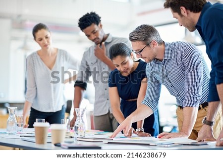 Theyve got planning down to a fine art. Mature man describing a plan of action to his diverse creative team. Royalty-Free Stock Photo #2146238679