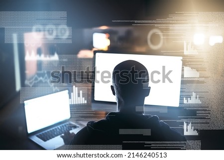 He understands the power of complexity. Rearview shot of a young male hacker cracking a computer code in the dark.