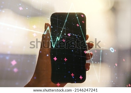 Creative abstract heart pulse hologram and hand with mobile phone on background, online medical consulting concept. Multiexposure