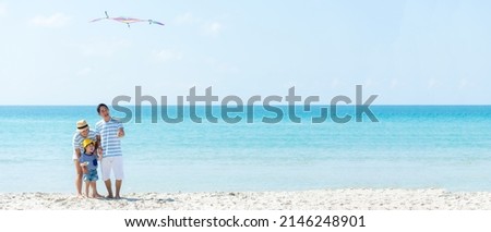 Asian happy family have fun and play kite on the beach.  Family people tourism travel in summer and holiday  for leisure and destination. Travel and Family Concept, copy space for banner Royalty-Free Stock Photo #2146248901