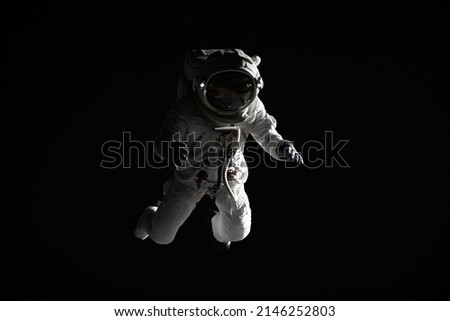 Full portrait of Caucasian female astronaut during spacewalk, black deep space background Royalty-Free Stock Photo #2146252803