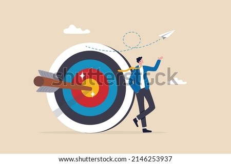 Business objective, purpose or target, goal and resolution to aim for success, aspiration and motivation to achieve goal concept, confident businessman stand with arrow hit bullseye on archery target. Royalty-Free Stock Photo #2146253937