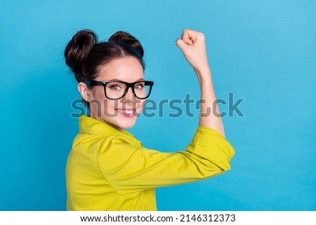 Photo of successful chief manager girl career development raise biceps up overcome hurdle isolated blue color background