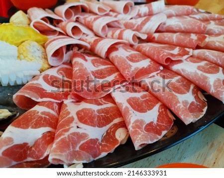 Pork neck slides arranged on a plate