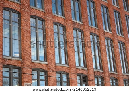 Beautiful Tall Windows spread across Old New England Mill Building: Clinton, Massachusetts Royalty-Free Stock Photo #2146362513