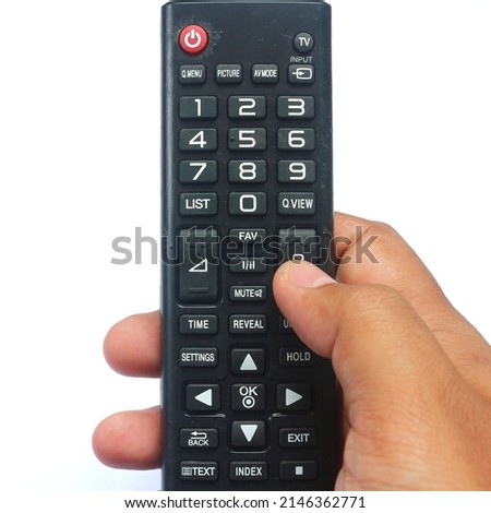 right hand holding black remote control for tv on white background