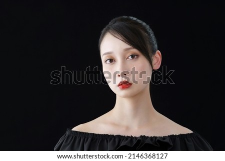 Young woman and black background