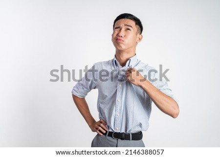 young asian man with tshirt feeling hot weather Royalty-Free Stock Photo #2146388057