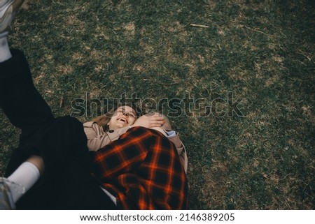 young couple laying on grass. summer love outdoors