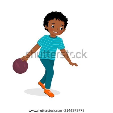 cute little African boy playing bowling in the sport club ready to throw the ball