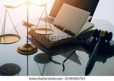 law books and scales of justice on desk in library of law firm. jurisprudence legal education concept. Royalty-Free Stock Photo #2146406763