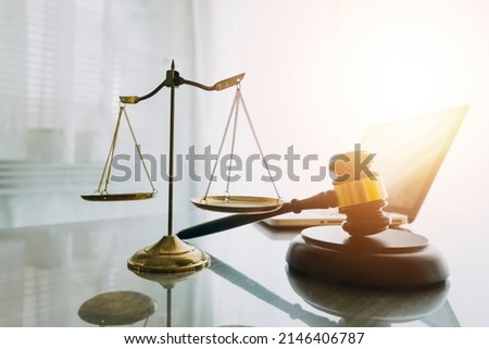 law books and scales of justice on desk in library of law firm. jurisprudence legal education concept. Royalty-Free Stock Photo #2146406787