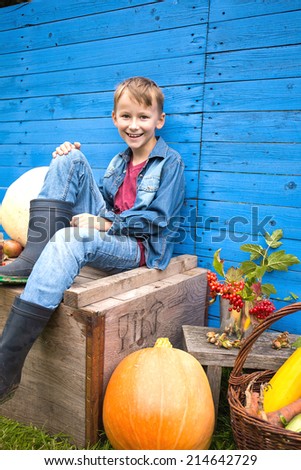 Boy holding fresh vegetables from the harvest