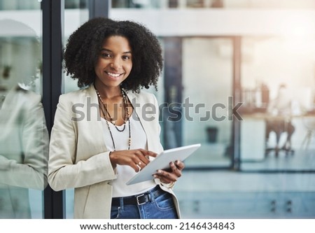 Make it your business to be tech savvy and industrious. Portrait of a young businesswoman smiling and holding a digital tablet in her office. Royalty-Free Stock Photo #2146434843