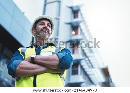 Youll always get a solid foundation with him. Shot of a engineer standing in front of a building. Royalty-Free Stock Photo #2146434973