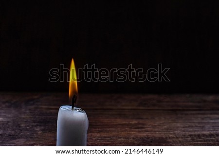 isolate burning candle on dark background .Candle light in darkness as light for life .