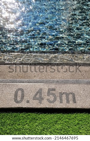 Pool depth warning sign on swimming poll side. Showing swimming pool depth of 0.45 meter. Selective focus image. Royalty-Free Stock Photo #2146467695