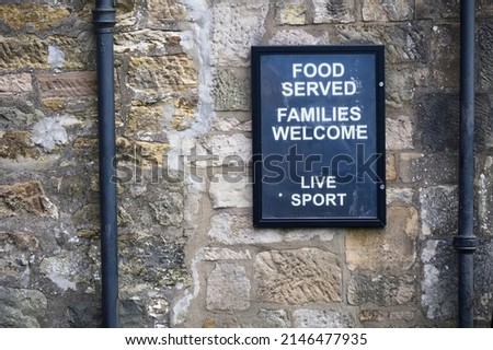 Food served families welcome sign on wall of restaurant