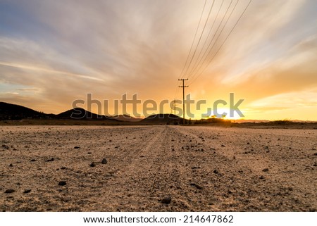 The dirt road on a beautiful Southern California sunset. Royalty-Free Stock Photo #214647862