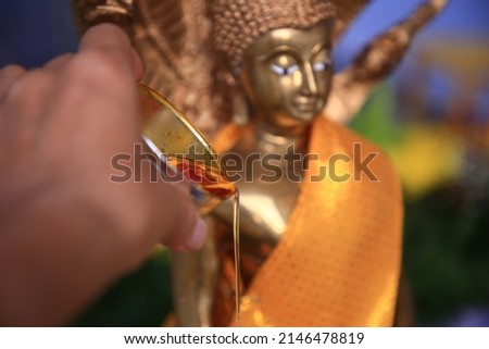 Songkran Festival or Thai New Year,Pour water and flowers on the Buddha for happy in songkran festival,gives blessing in Songkran day concept,