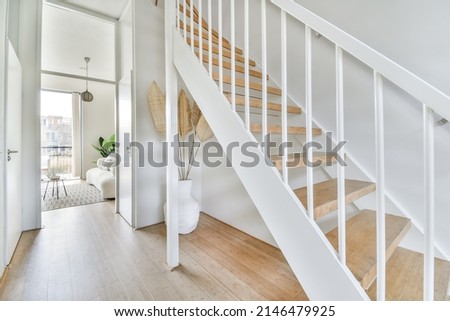 A spacious bright corridor leading to the living room and also to the second floor up the stairs Royalty-Free Stock Photo #2146479925
