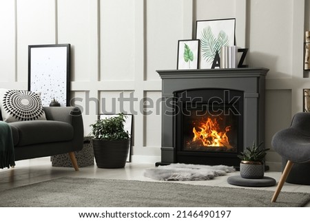 Stylish living room interior with electric fireplace and comfortable furniture