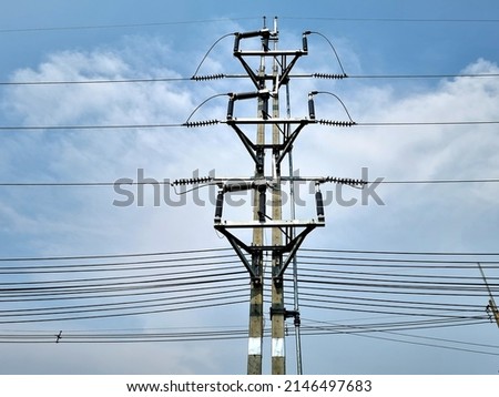 115 kV Load Break Switch at an open position on blue sky background.