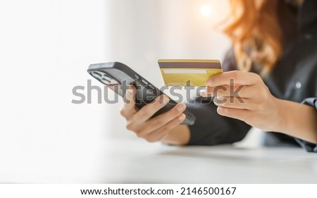 Women holding credit card and using smartphones at home.Online shopping, internet banking, store online, payment, spending money, e-commerce payment at the store, credit card, concept Royalty-Free Stock Photo #2146500167
