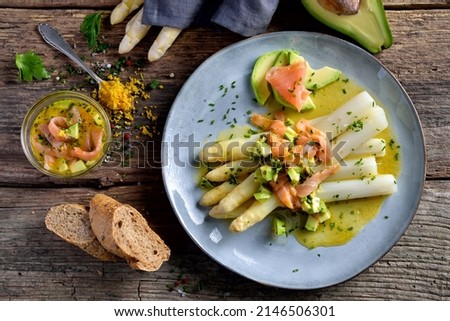 Fresh white asparagus with lemon orange vinaigrette with avocado and smoked salmon Royalty-Free Stock Photo #2146506301