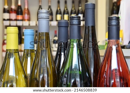 Wine shop with a wide selection of goods. Lots of wine bottles in the wine shop. Large selection of wine. Royalty-Free Stock Photo #2146508839