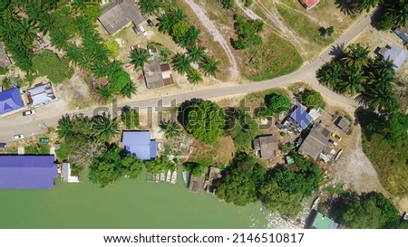 Aerial drone view of rural settlements by the riverside in Sedili Kecil, Johor, Malaysia