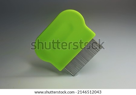 green lice comb floating, isolated on a grey background