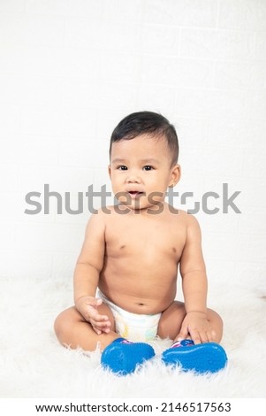 a little boy is sitting, wearing blue shoes with various cute expressions