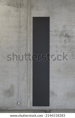 Industrial concrete wall with space for information or advertising. Installation with an electric socket.
