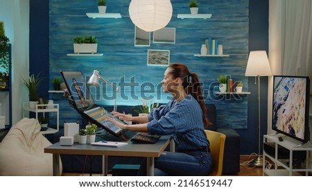 Professional editor using retouching software for photos design at studio with photography equipment and technology. Media artist editing pictures with computer and touch screen monitor