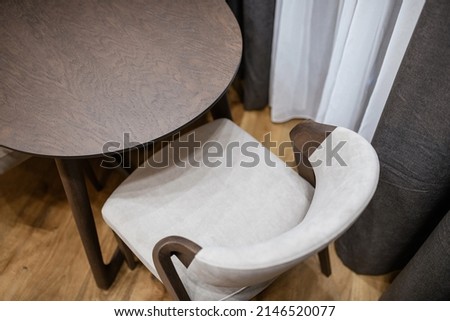 light soft new clean chair and dark table made of natural wood in the kitchen