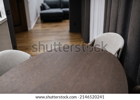round dark wooden table and chairs in the interior design of the house