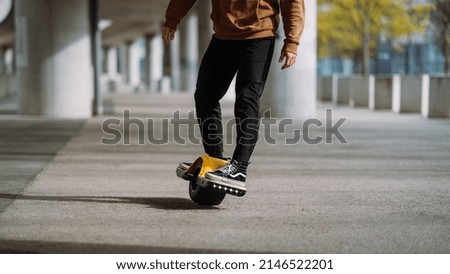 Close up leg shot of a skater with electric skateboard.