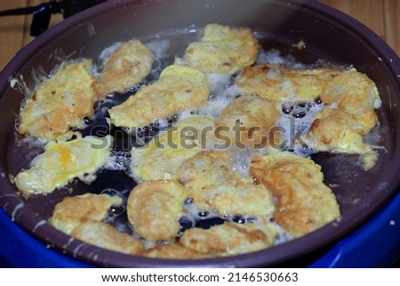 Close-up of Korean Food Jeon(Pollack Pancake) cooking in oil on a frying pan, South Korea
