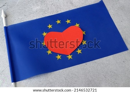 Flag of Europe with red heart symbol, european union flag on gray background, Europe Day 5th and 9th of May, Schumann Declaration day, I love Europe concept Royalty-Free Stock Photo #2146532721