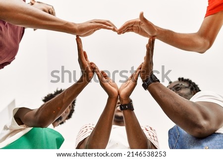 Group of young african american artist man smiling happy doing heart symbol with hands at art studio.