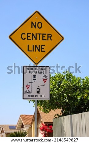 No Center Line and Vehicles Share Center Lane and Yield to Bikes signs. Confusing two way shared single lane signs in San Diego, California. Royalty-Free Stock Photo #2146549827