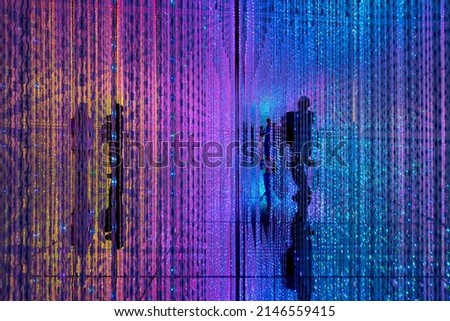 Digital Life concept. Abstract of shadow of person standing in middle of a room full of infinite colorful LED light illumination. Royalty-Free Stock Photo #2146559415