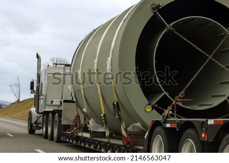 Heavy-duty trailer with a transportation of bulky goods on a traffic road Royalty-Free Stock Photo #2146563047