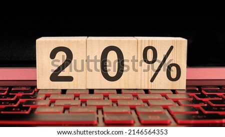 20 percent a word on wooden cubes on the illuminated laptop keyboard..