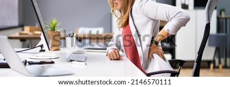 Back Pain Bad Posture Woman Sitting In Office Royalty-Free Stock Photo #2146570111