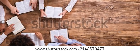 Elevated View Of People Reading Holy Books On Wooden Background Royalty-Free Stock Photo #2146570477