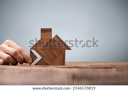 Miniature House Puzzle Pieces And Tangram. Wooden Toy Real Estate Royalty-Free Stock Photo #2146570819